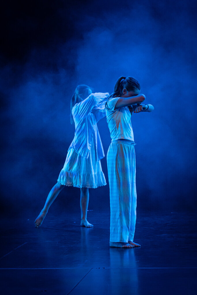 Dance photography. The image has horizontal lines over it as a result of the camera's sensor and the frequency of the LED lights not working well together.