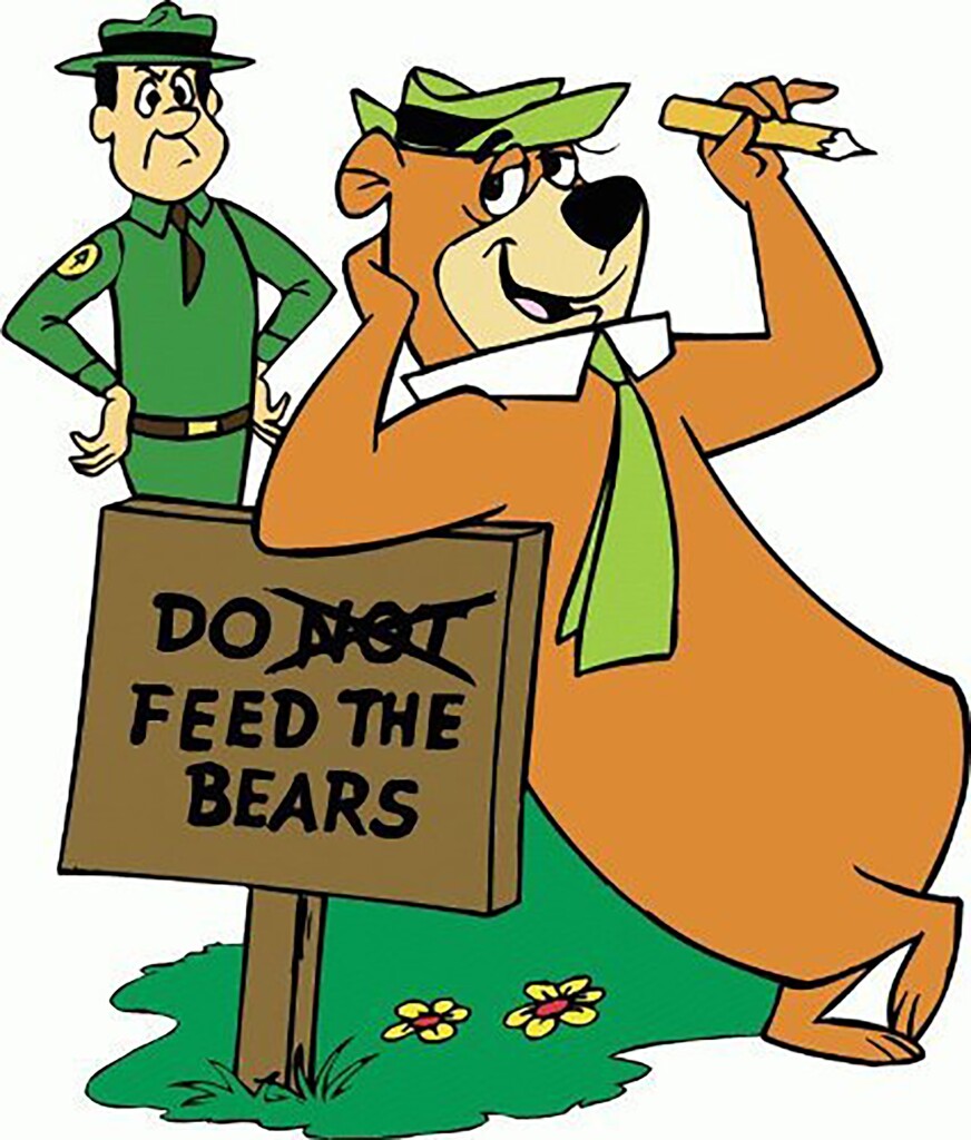 Picture of Yogi Bear leaning on a signpost that says "Do not feed the bears" ...the "not" is crossed out

In the background is the park ranger (forgot the name, sorry) looking angry.