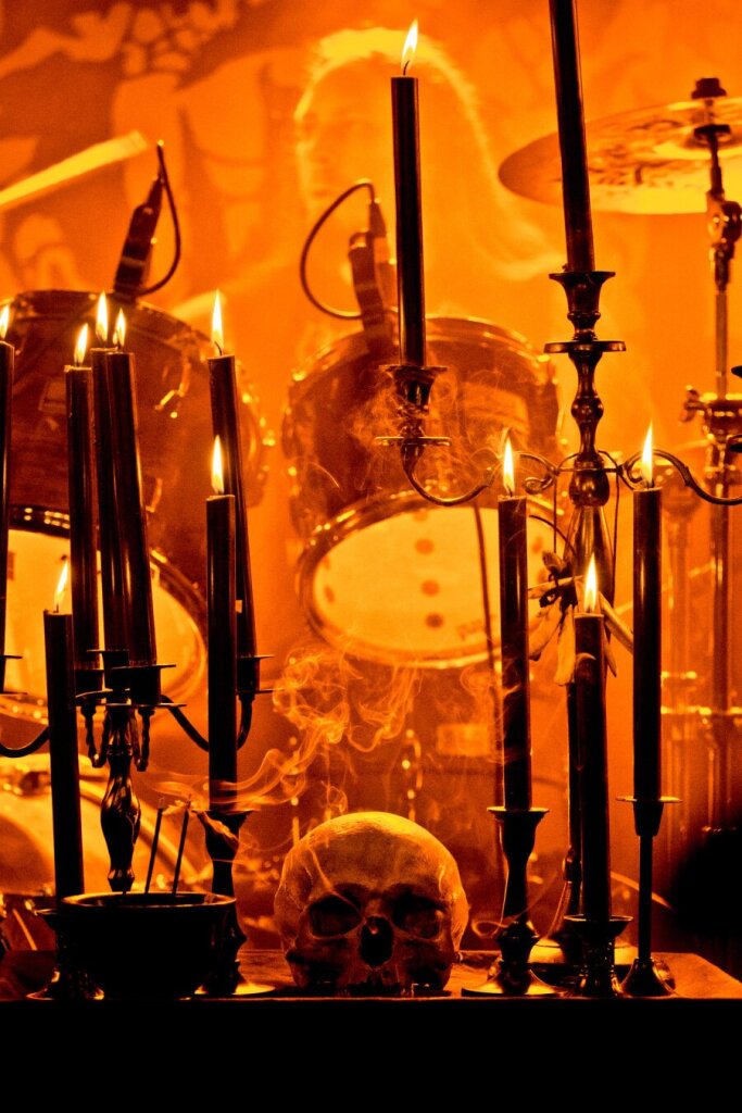 A human skull and black candles. Black and orange.