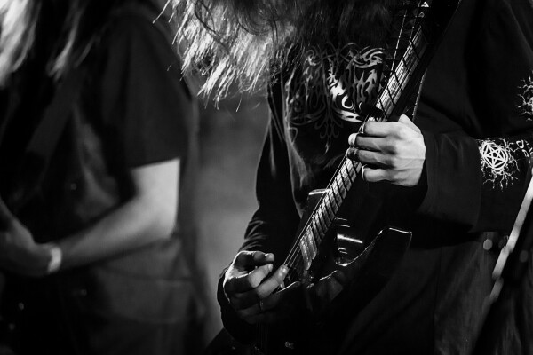 Close-up of a guitar being played.